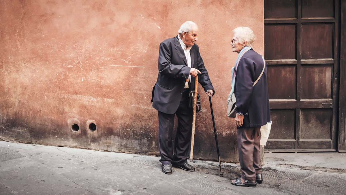 Senior man using a walking cane on a neighborhood path